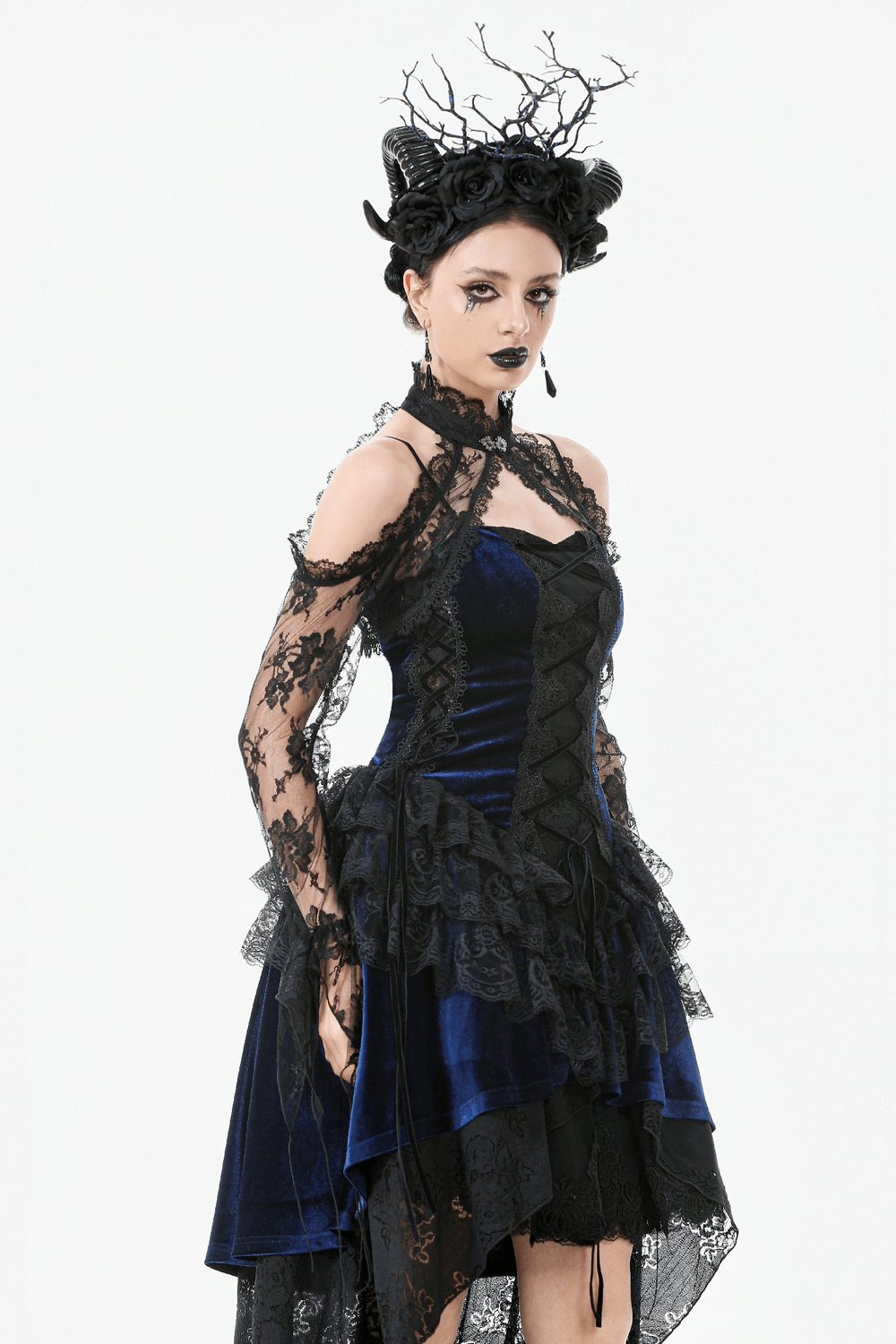 Model wearing a Gothic black floral lace shrug with long flared sleeves over a blue dress, showcasing vintage charm.