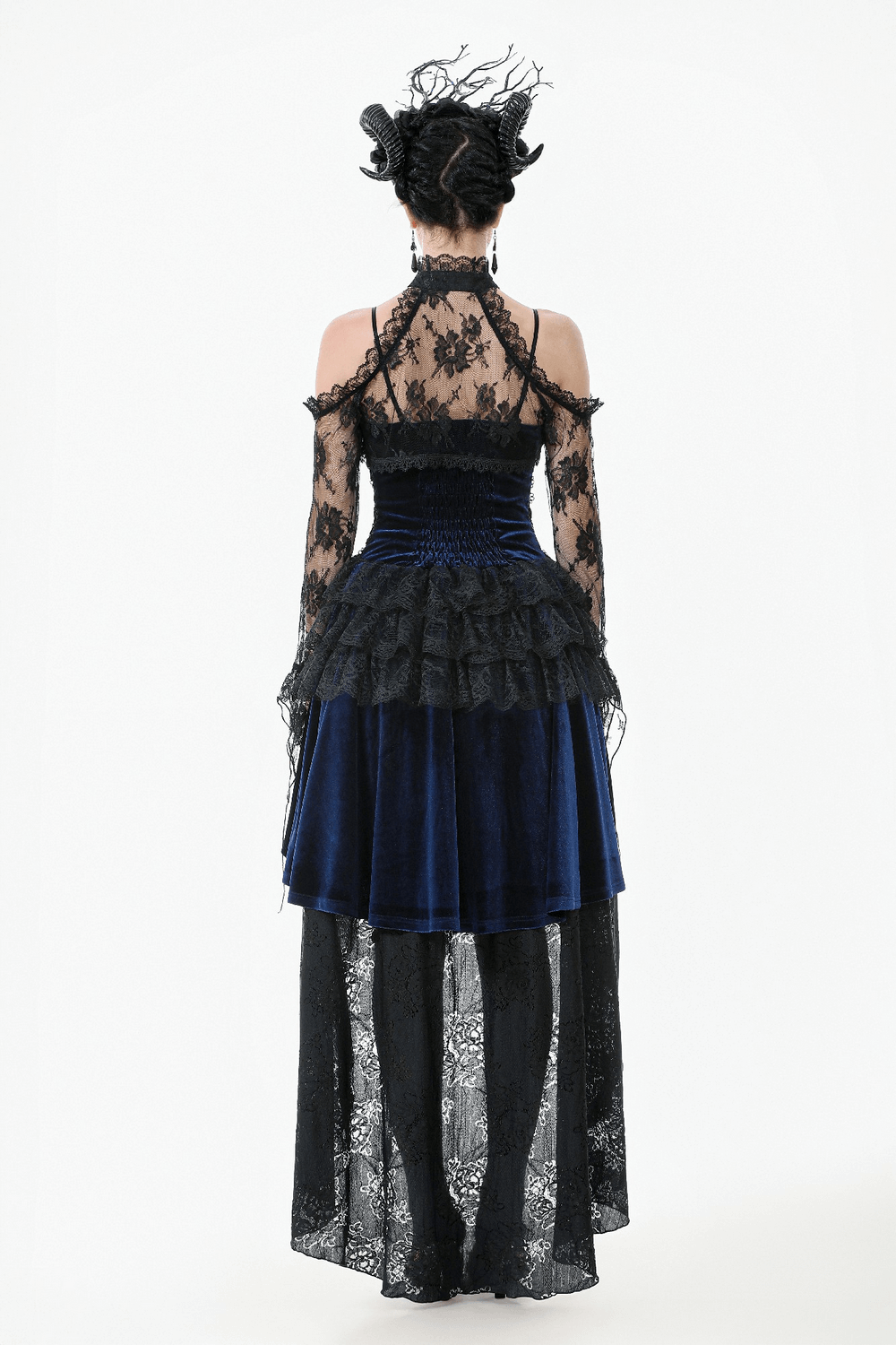 Back view of a model in a gothic black floral lace shrug with flared sleeves over a velvet dress.