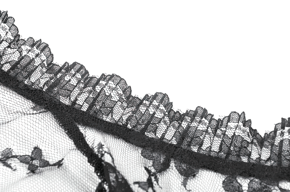 Close-up of intricate black floral lace with scalloped edges, perfect for gothic and alternative fashion.