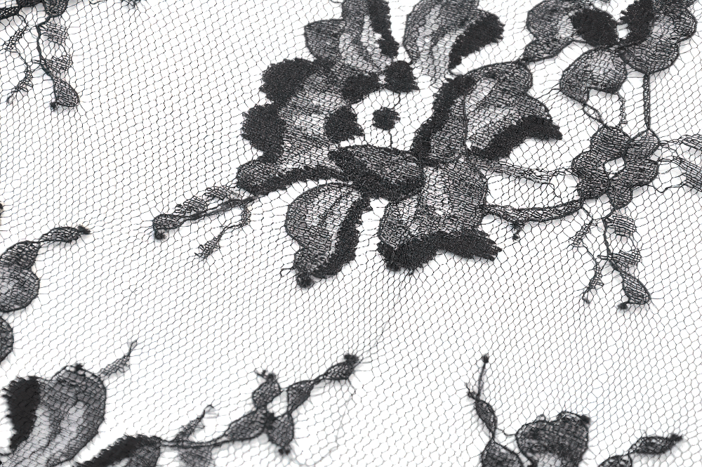 Delicate black floral lace fabric with intricate designs, perfect for gothic and vintage fashion.