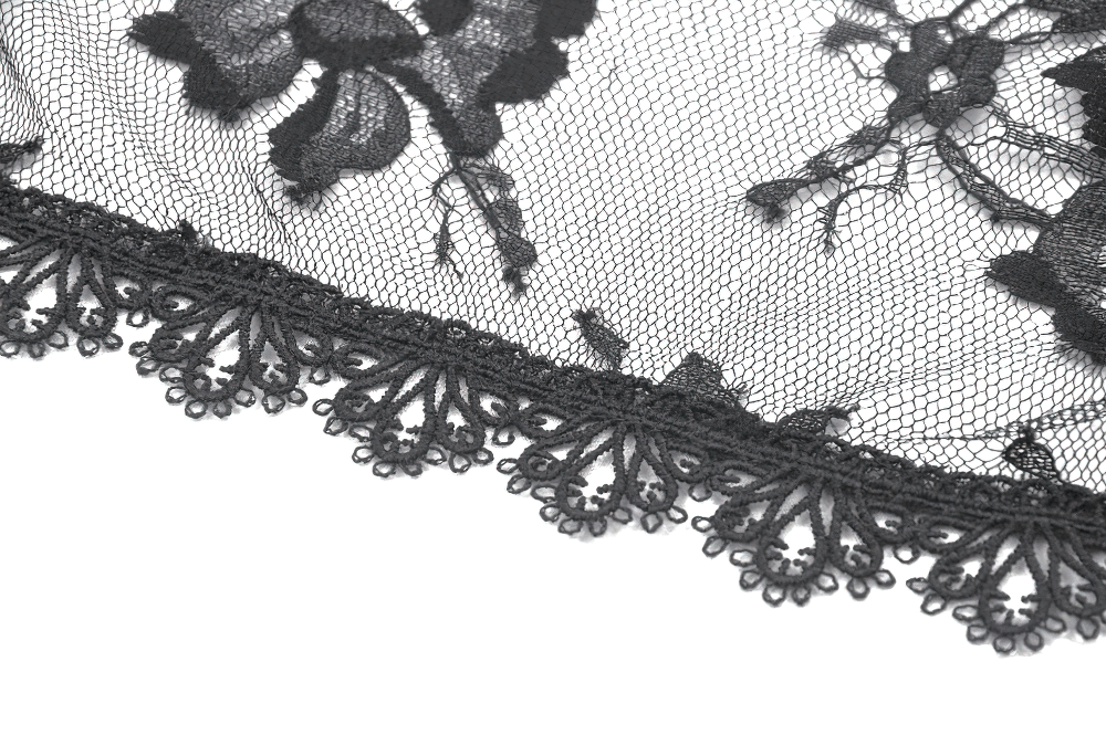Close-up of black floral lace fabric with intricate scalloped edges, perfect for gothic or vintage styles.