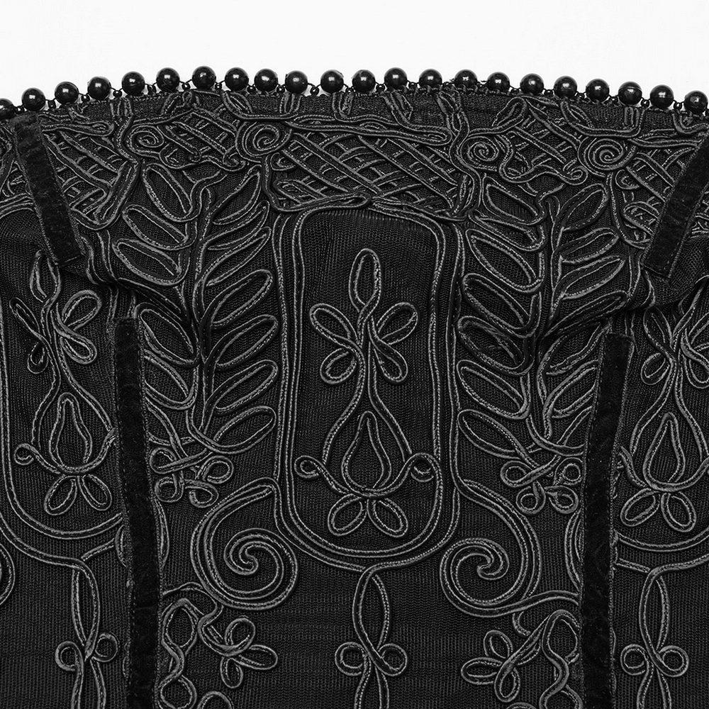 Close-up of intricate black floral embroidery and beaded neckline detail on a gothic dress, showcasing elegant craftsmanship.