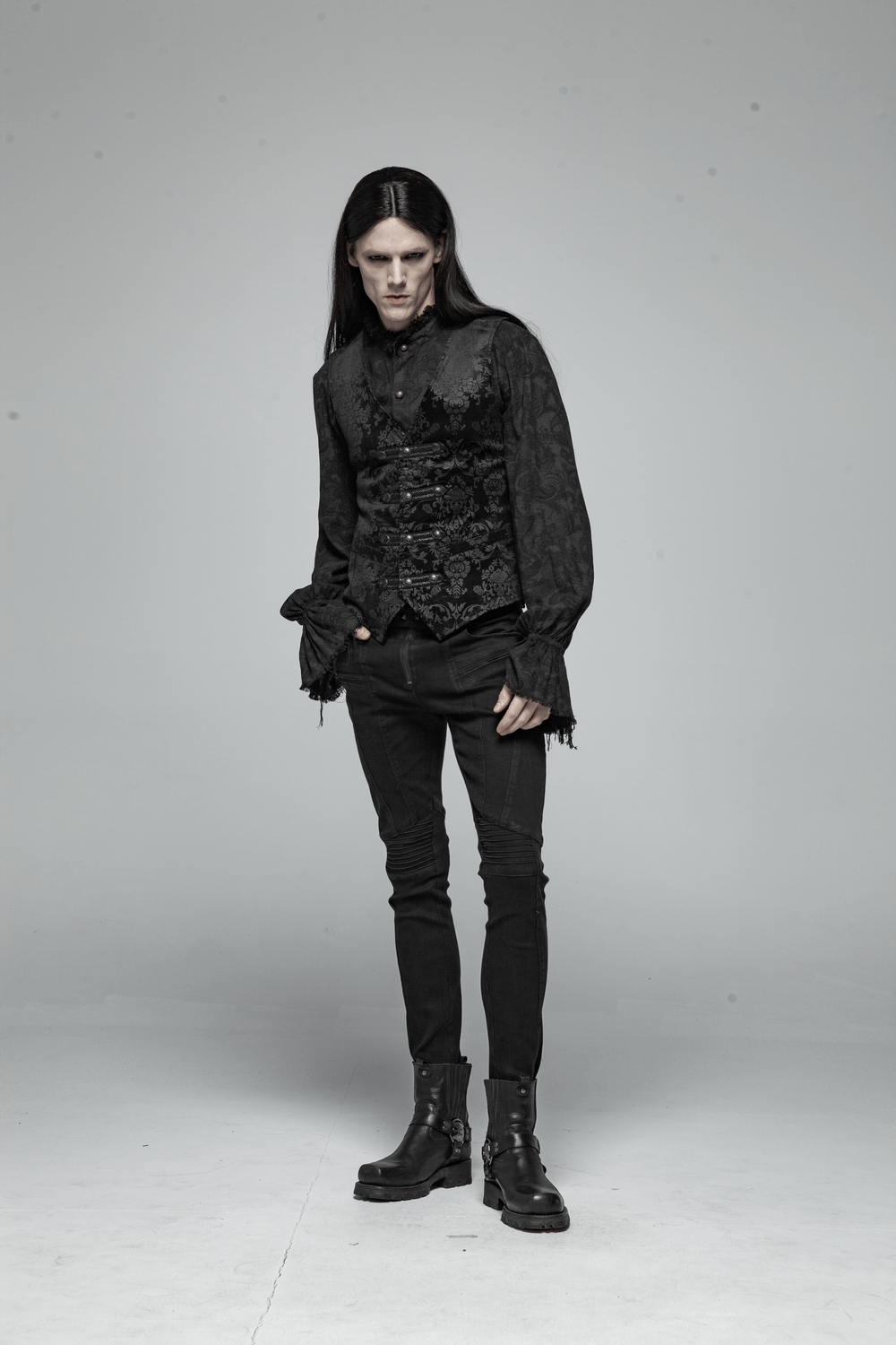 Gothic black floral vest styled with black pants and boots, showcasing Victorian elegance and modern fashion.