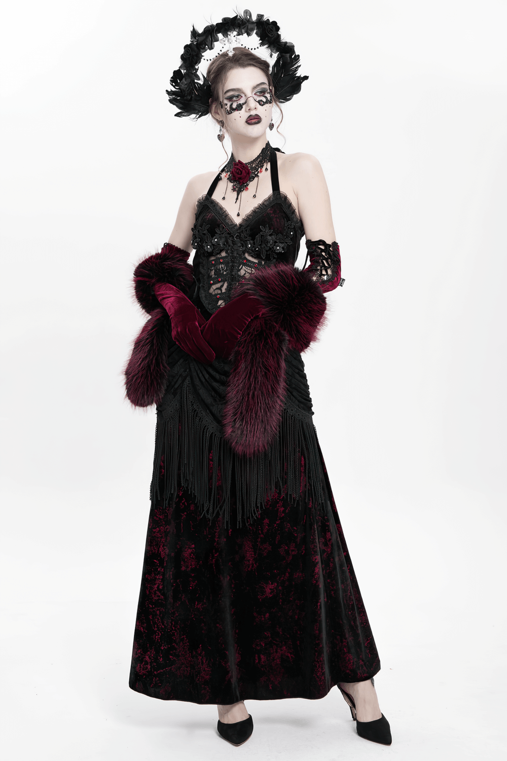 Gothic model in a black and burgundy dress, wearing a feathered halo crown, ready for an elegant dark fantasy event.