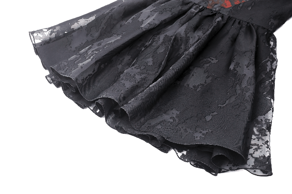 Close-up of the ruffled hem of a Gothic black dress with intricate lace details, showcasing its elegant vintage design.