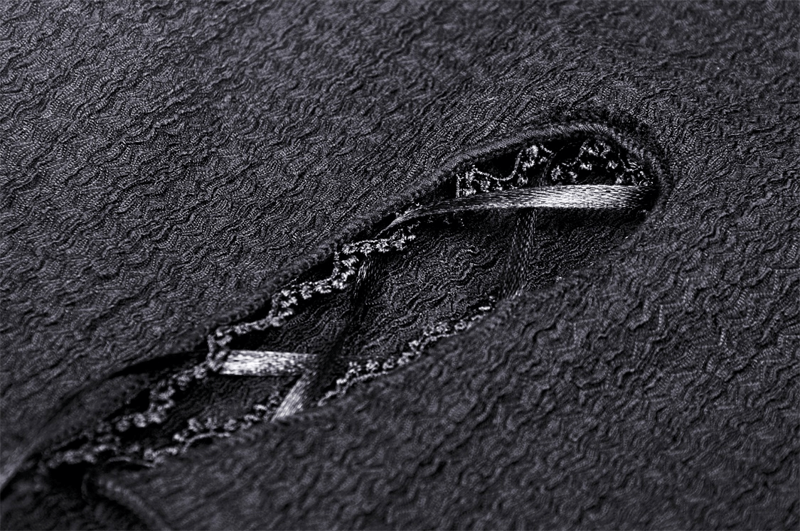 Close-up of gothic black crop top showing lace detailing and textured fabric for an edgy style.