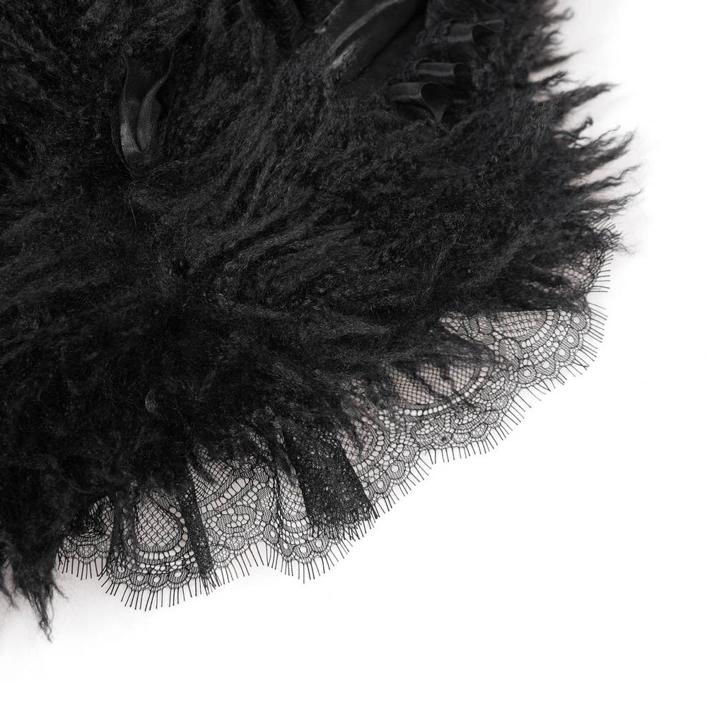 Close-up of black faux fur and lace detailing on a gothic hooded jacket, showcasing intricate texture and design.