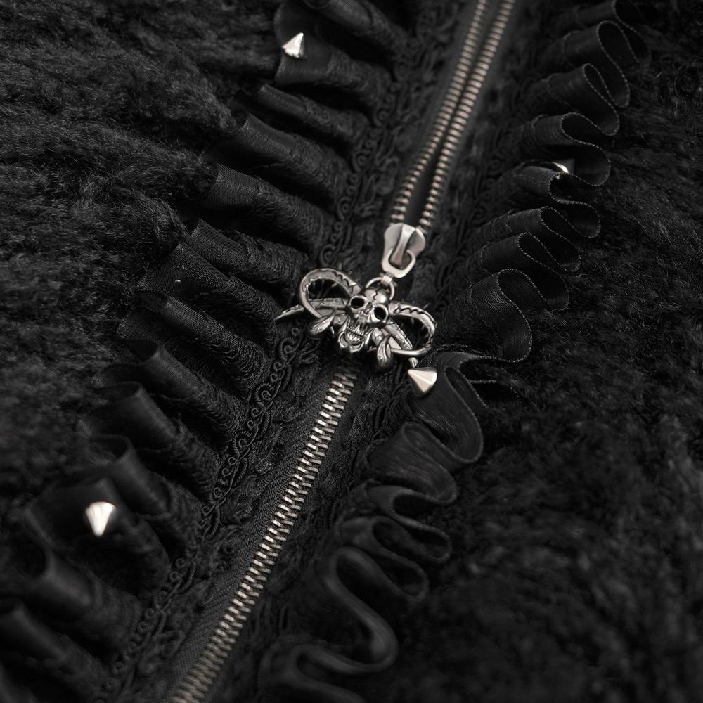 Close-up of gothic black jacket zipper with skull charm and ruffled detailing, showcasing dark fantasy style.