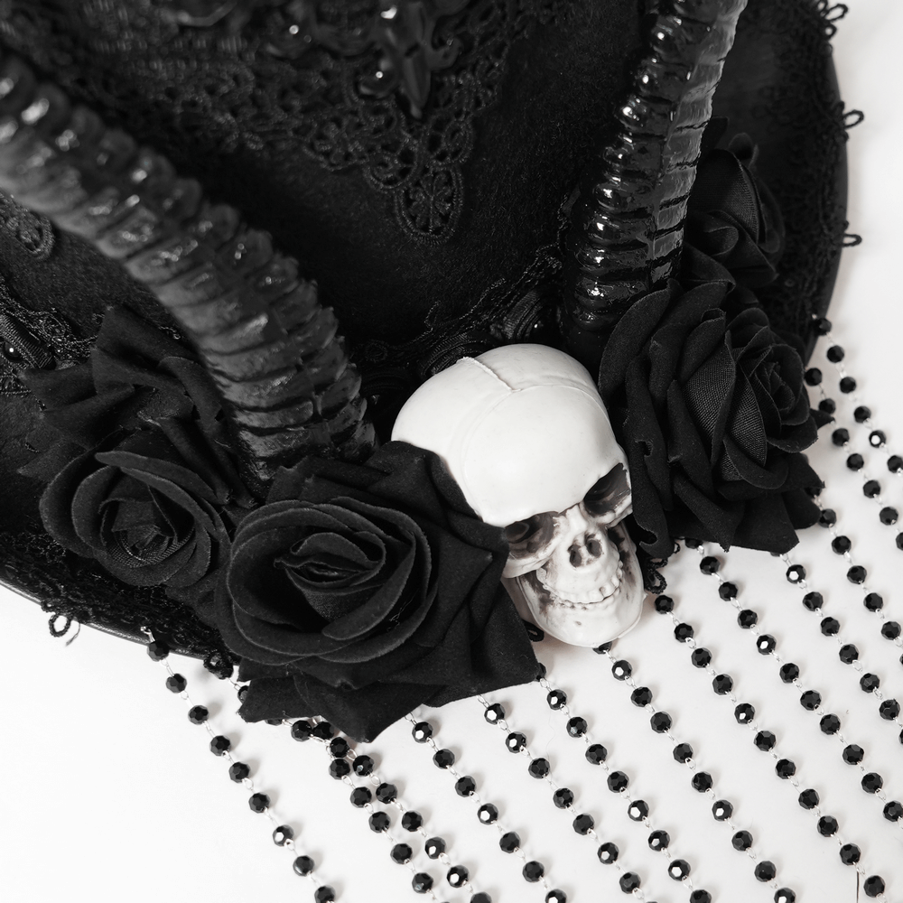 Gothic black horned top hat adorned with roses and a skull, featuring elegant lace and bead details.