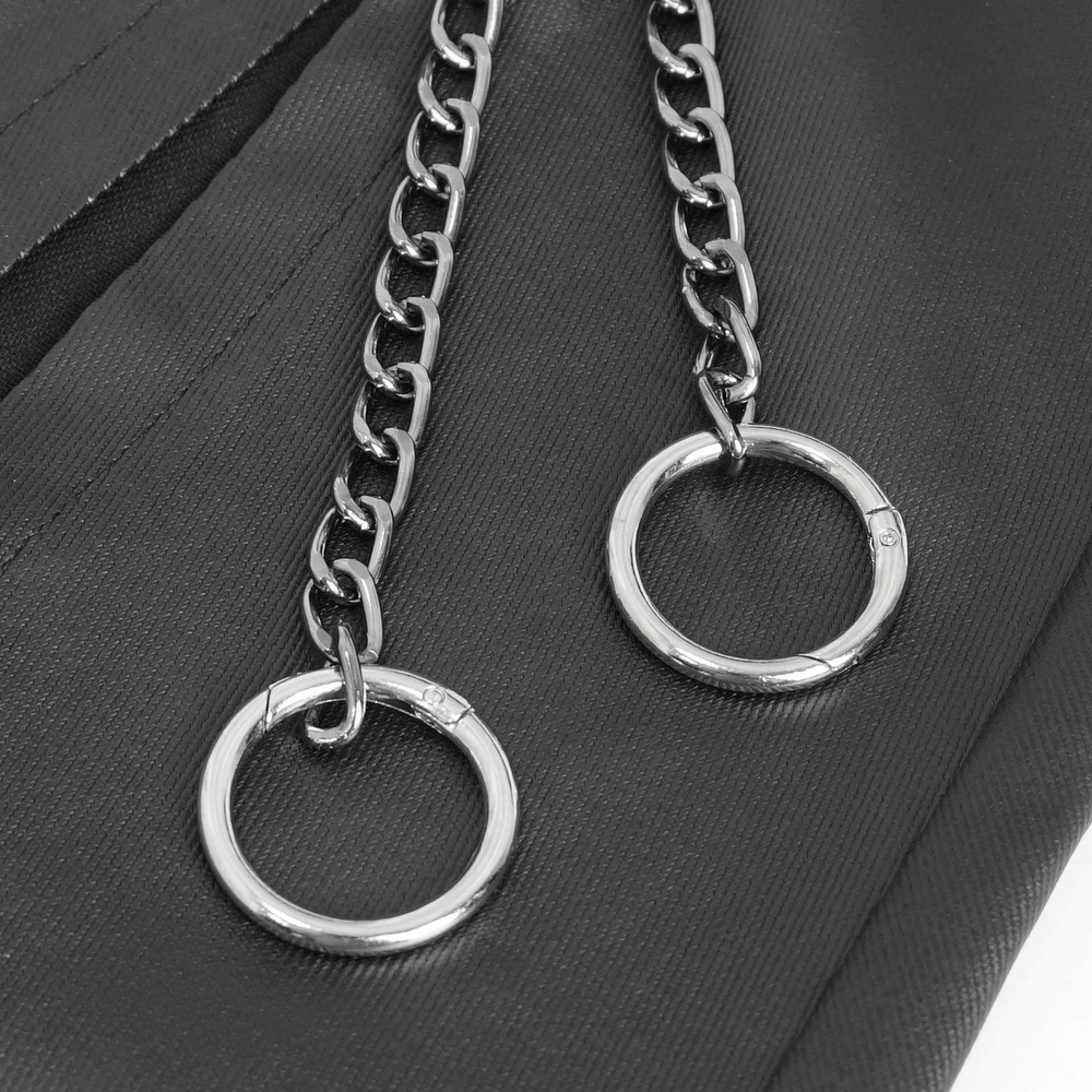 Close-up of chains and metal rings on a Gothic black kilt, showcasing punk style accessories.