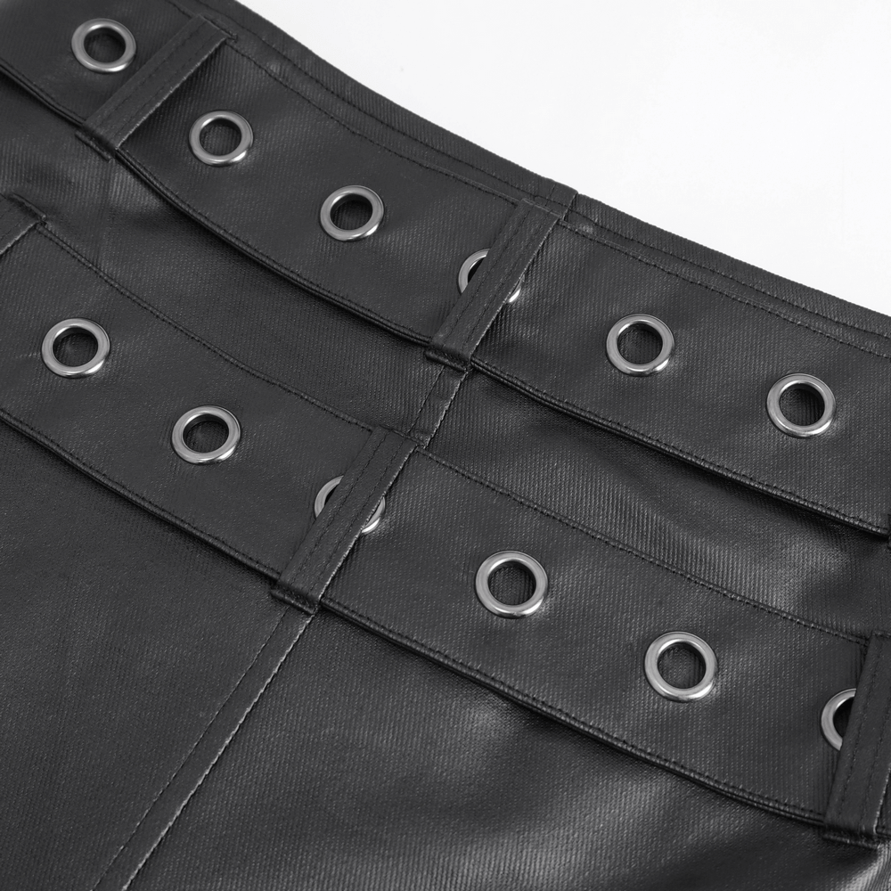 Close-up of Gothic black kilt showcasing metal grommets and ripped fabric for bold punk style.
