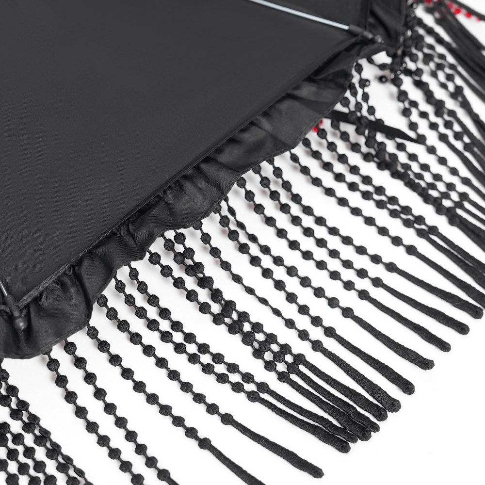 Gothic black lace umbrella detailing with red bead accents and beaded fringe.