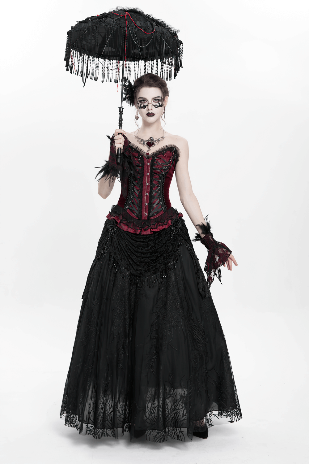 Gothic model in black lace gown holding a dramatic black lace umbrella with red bead accents.