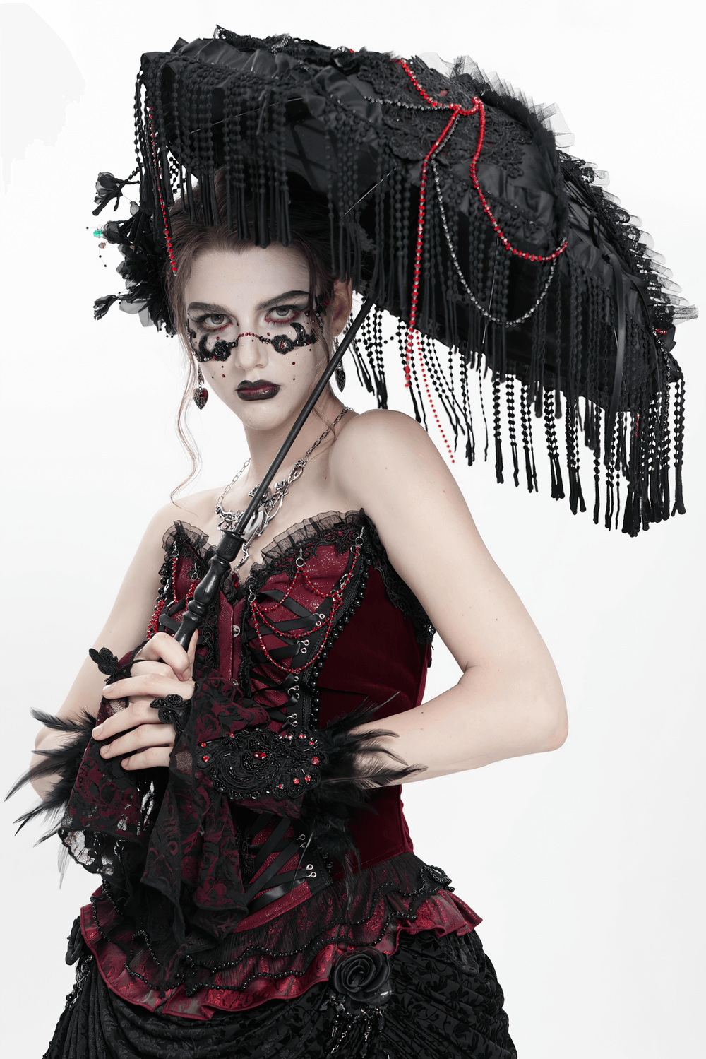 Gothic black lace umbrella with red bead accents, perfect for vintage-inspired fashion statements.