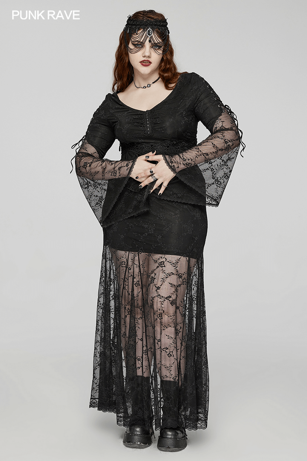 Gothic black lace dress with dramatic sleeves and a long sheer overlay, perfect for bold fashion statements.