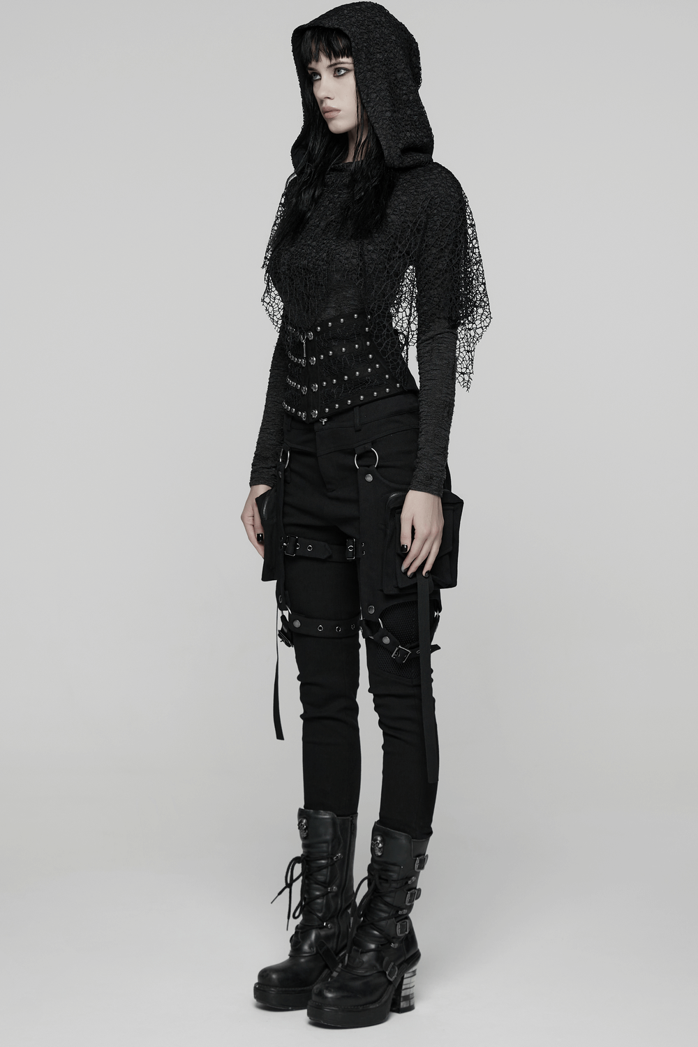 Gothic Black Lace and Rivet Waist Cincher Corset worn with black attire and combat boots, showcasing edgy style.
