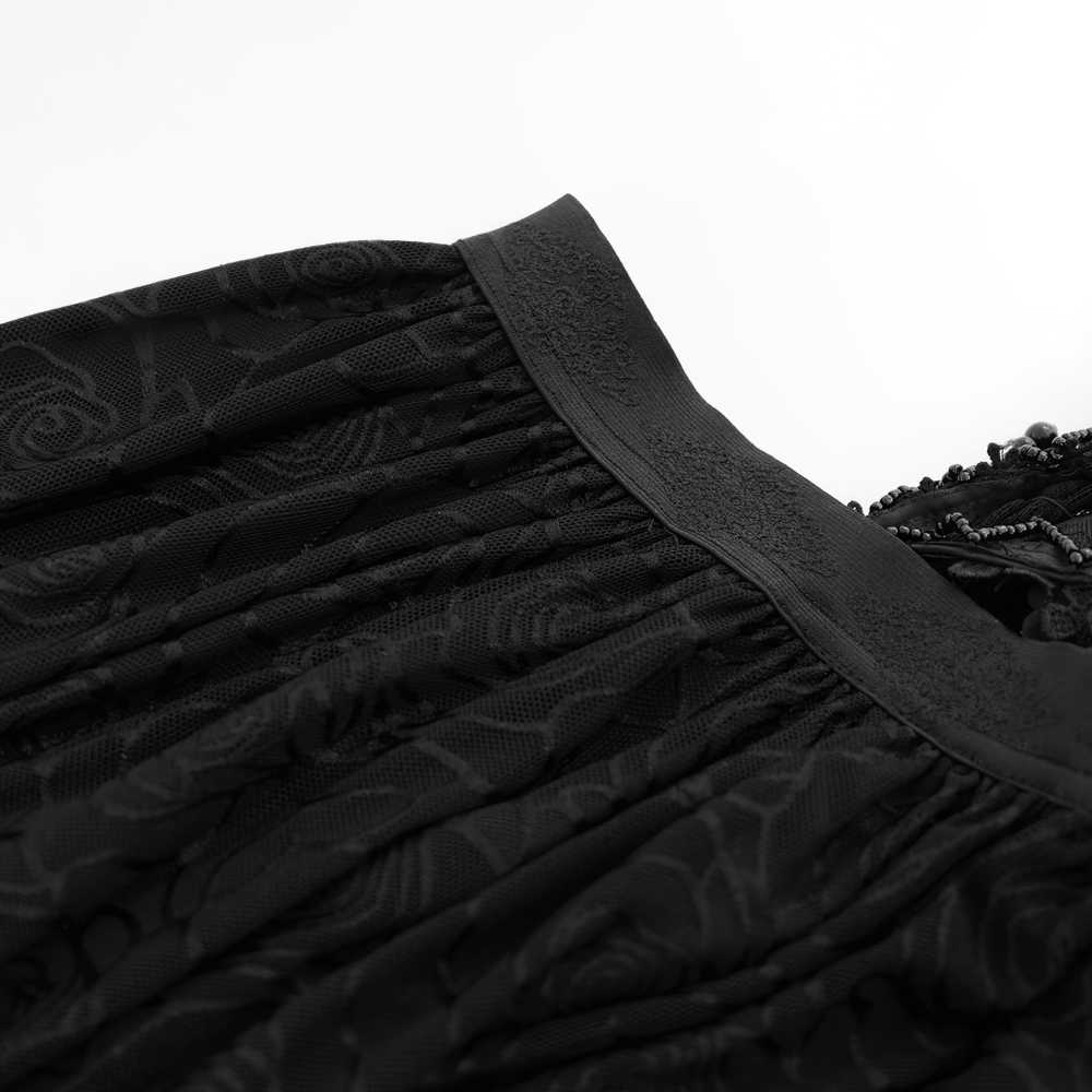 Close-up of the elegant black lace and rose corset dress with intricate detailing and flowing skirt fabric.