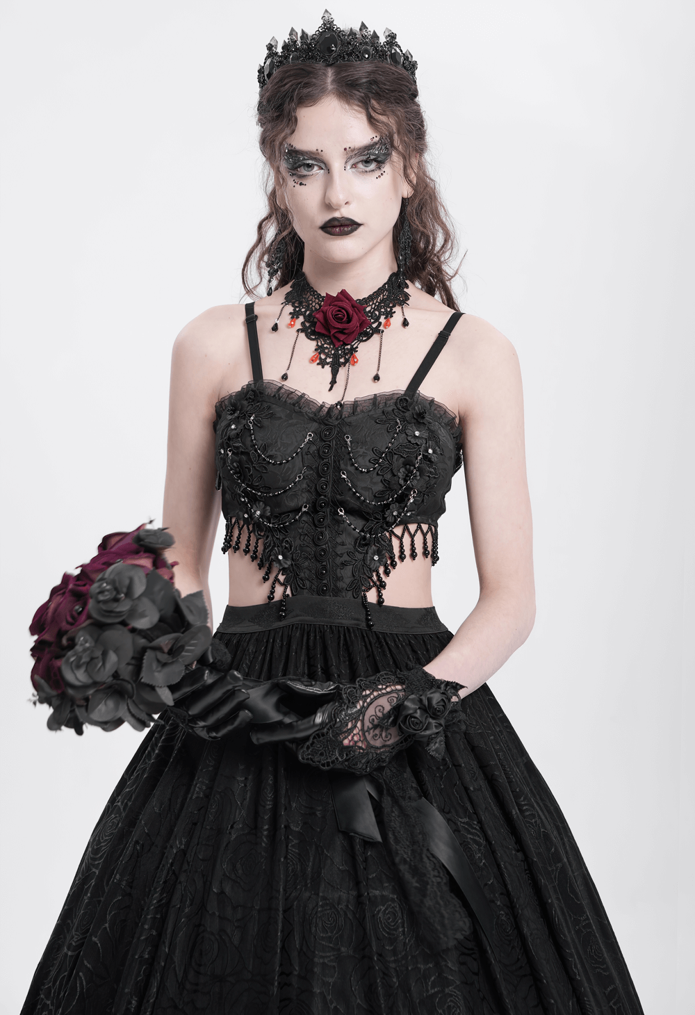 Gothic black lace corset dress with rose accents, featuring flowing skirt and elegant gothic accessories.