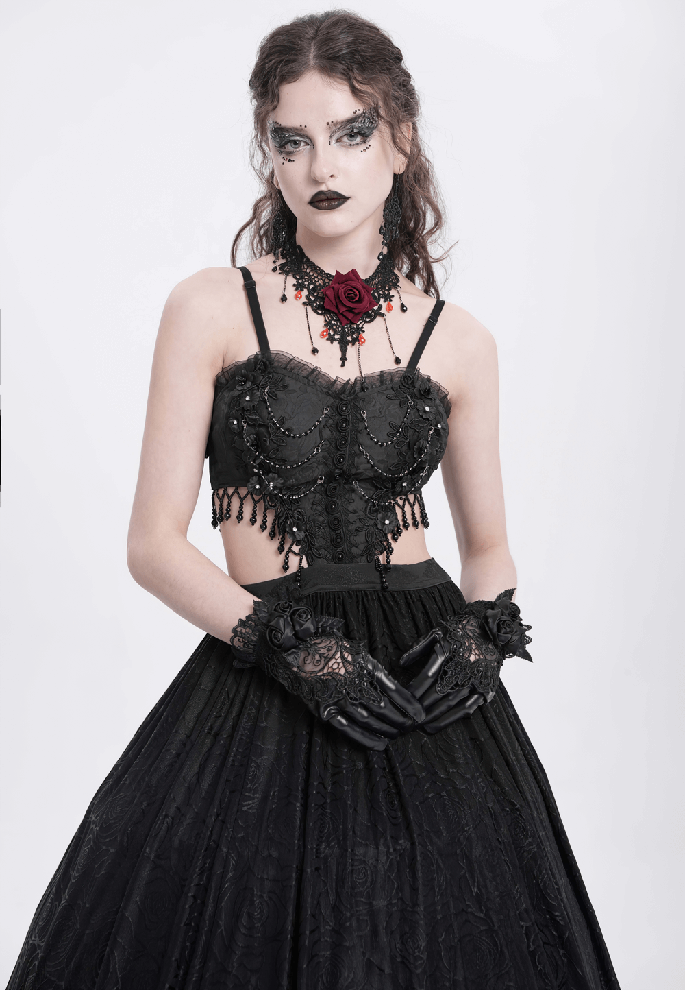 Elegant Gothic black lace corset dress with rose detail, flowing skirt, and dramatic accessories for dark glamour.