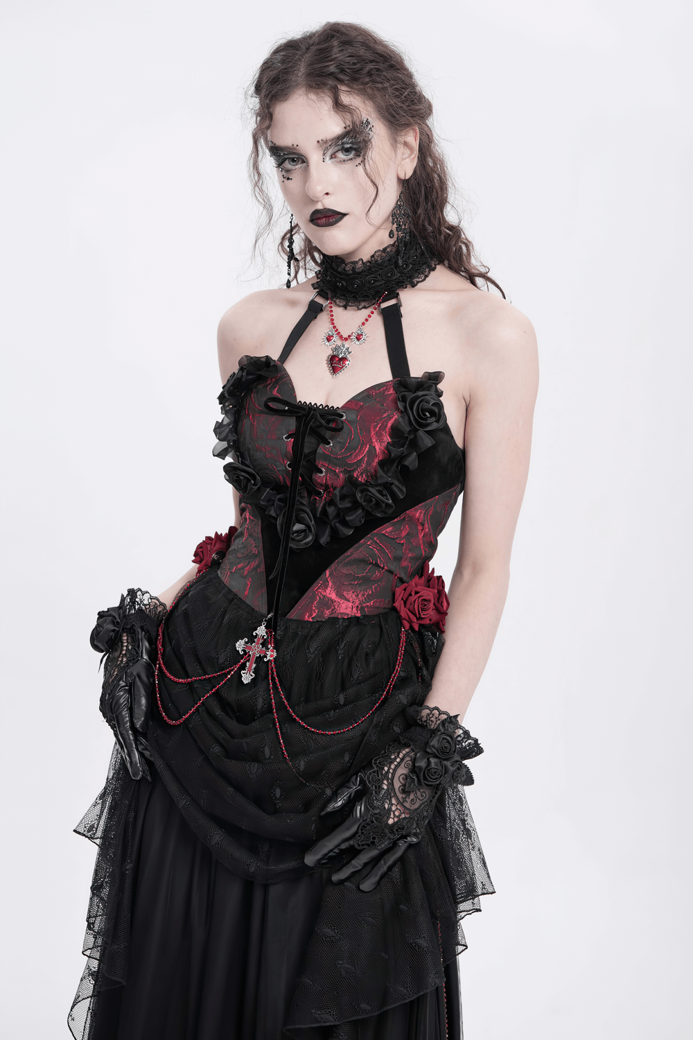 Gothic black lace and satin rose gloves enhance a dramatic Gothic outfit with ruffles and intricate detailing.