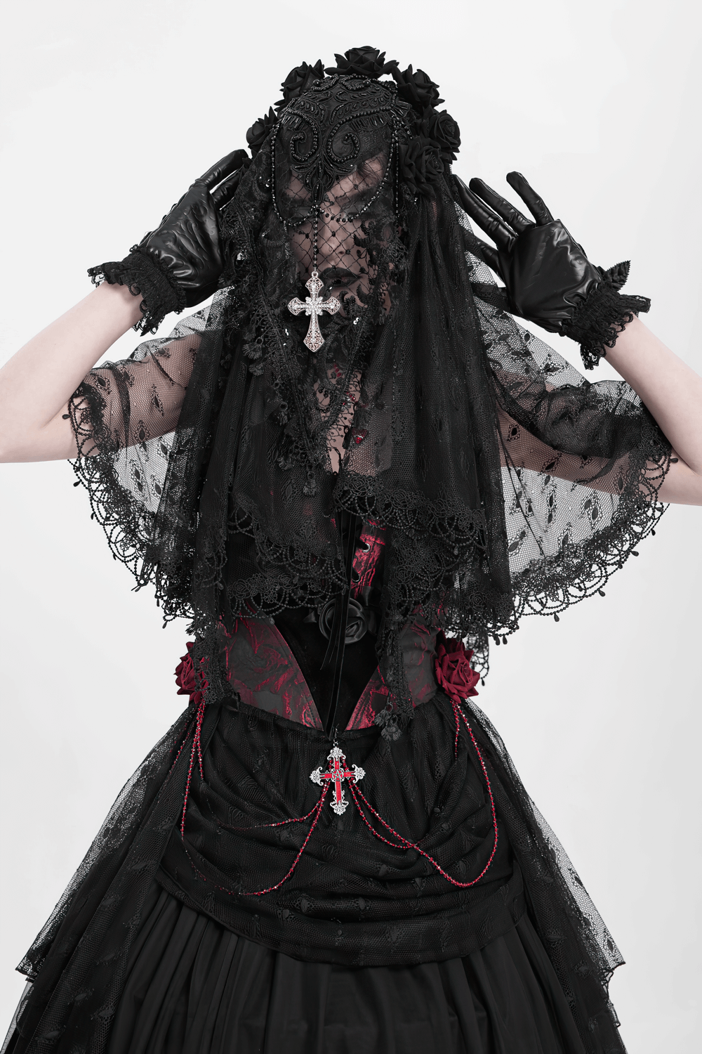 Gothic model in black lace veil and gloves, showcasing dark elegance with intricate details and vintage flair.