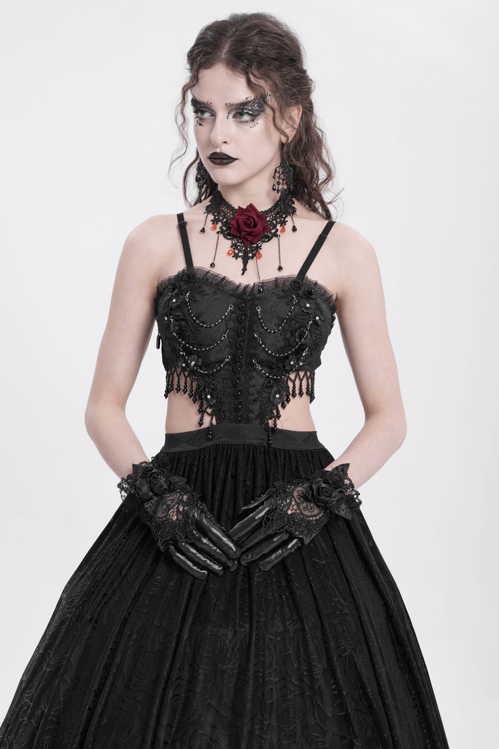 Elegant model wearing Gothic black lace and satin rose gloves, styled with a vintage black corset and dark makeup.
