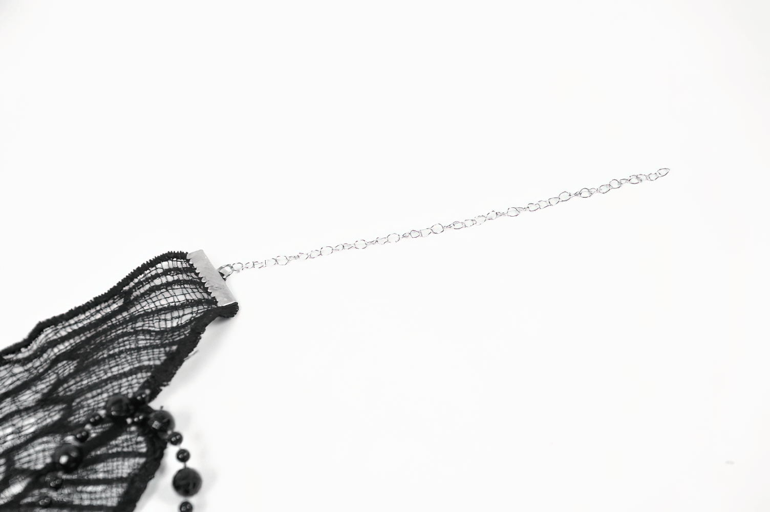 Gothic black lace butterfly choker with beaded accents and chain, showcasing dark elegance and Victorian charm.