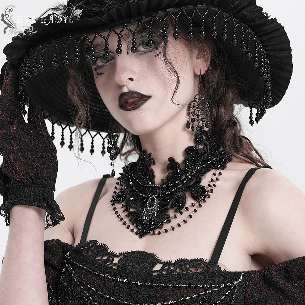 Gothic black lace choker necklace with beaded chains, black gem pendant, elegantly styled with a dramatic hat.