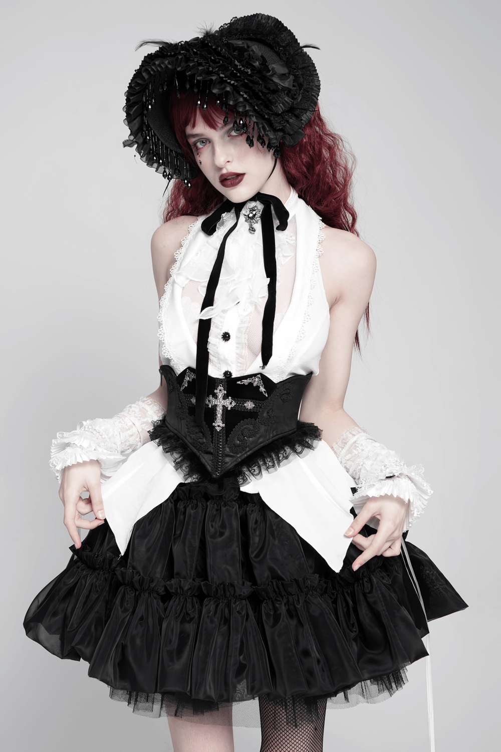Gothic black lace corset belt with cross embroidery styled in a dramatic Victorian outfit.