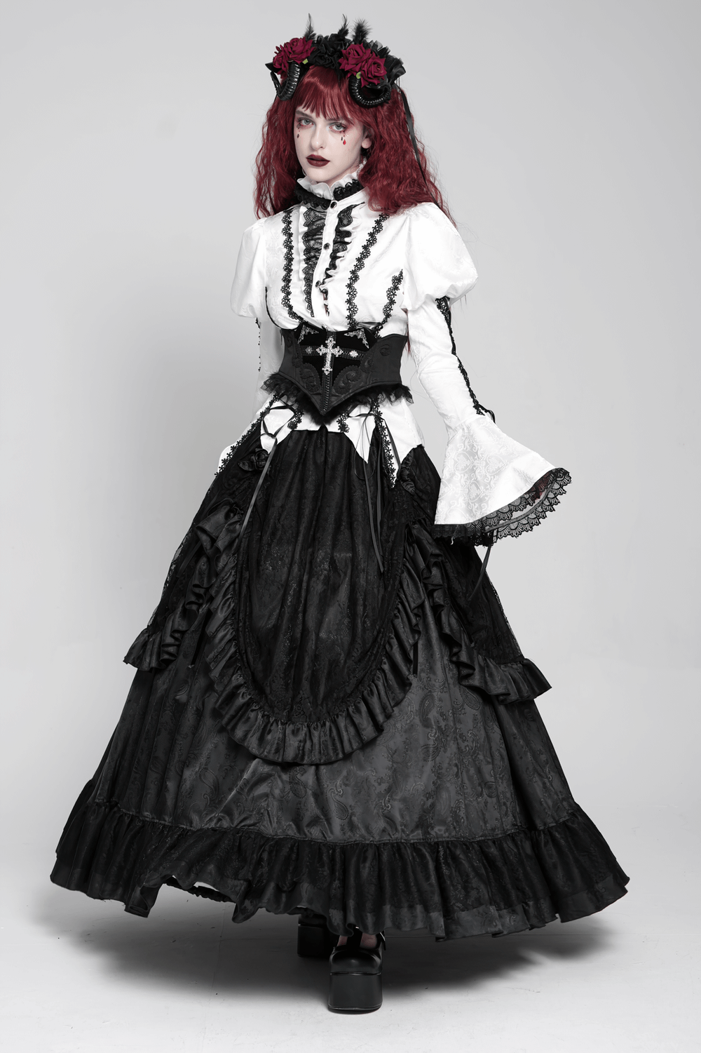 Gothic woman in black lace corset belt with cross embroidery, styled with a dramatic black and white Victorian gown.