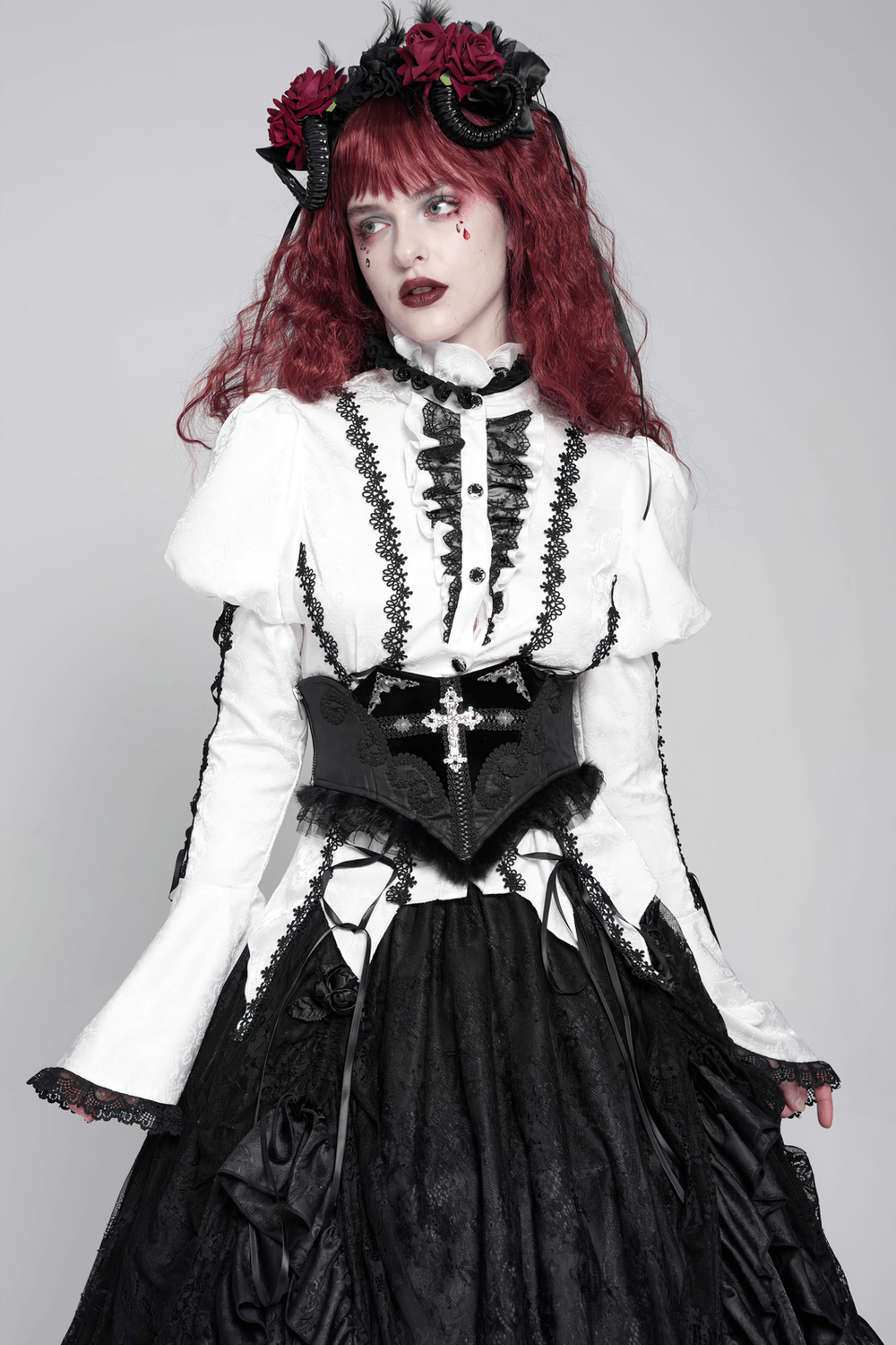 Gothic model in black lace corset belt with cross embroidery and elegant Victorian fashion attire.