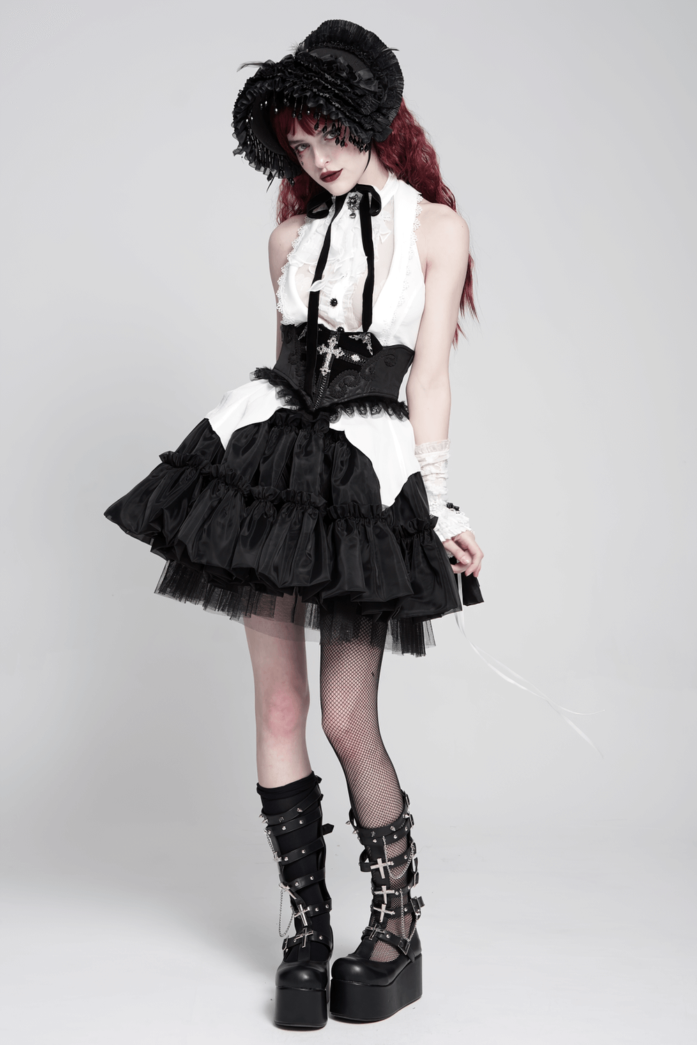 Model wearing a Gothic black and white outfit with a corset and lace trim, showcasing a bold Victorian look.