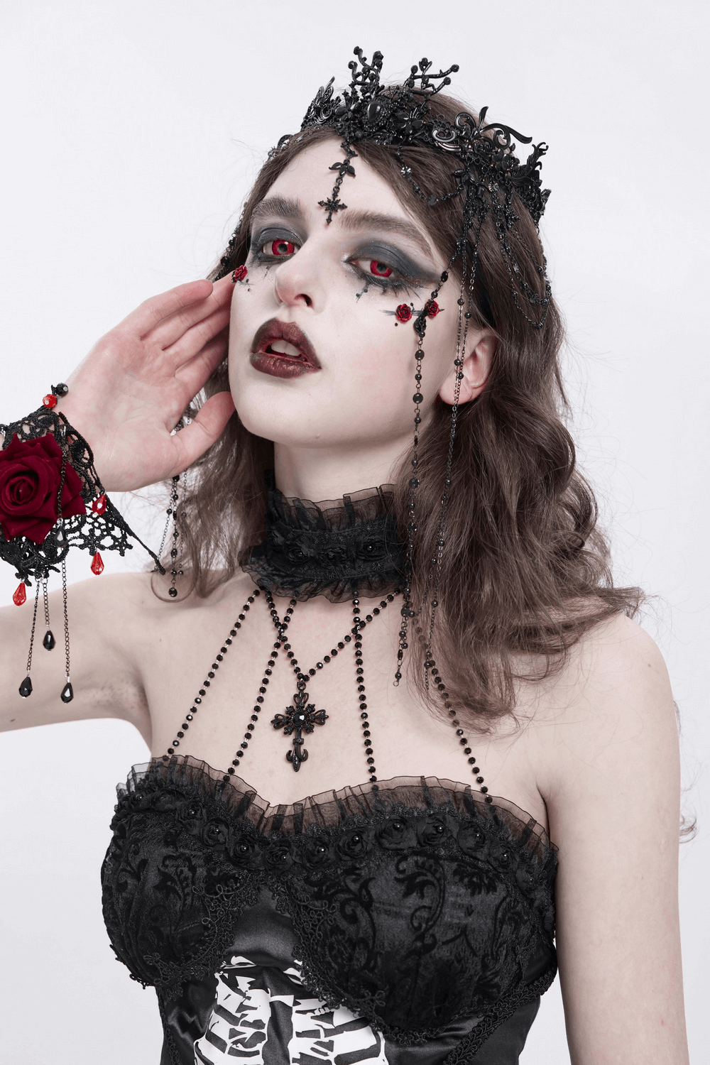 Gothic black lace crown with beaded chains, worn by a model with dark makeup and a dramatic outfit.