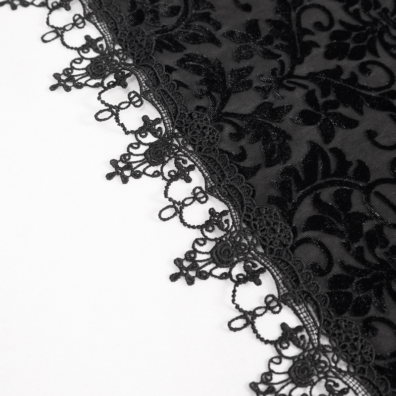 Close-up of elegant black lace with intricate floral patterns and detailed trim for gothic fashion.