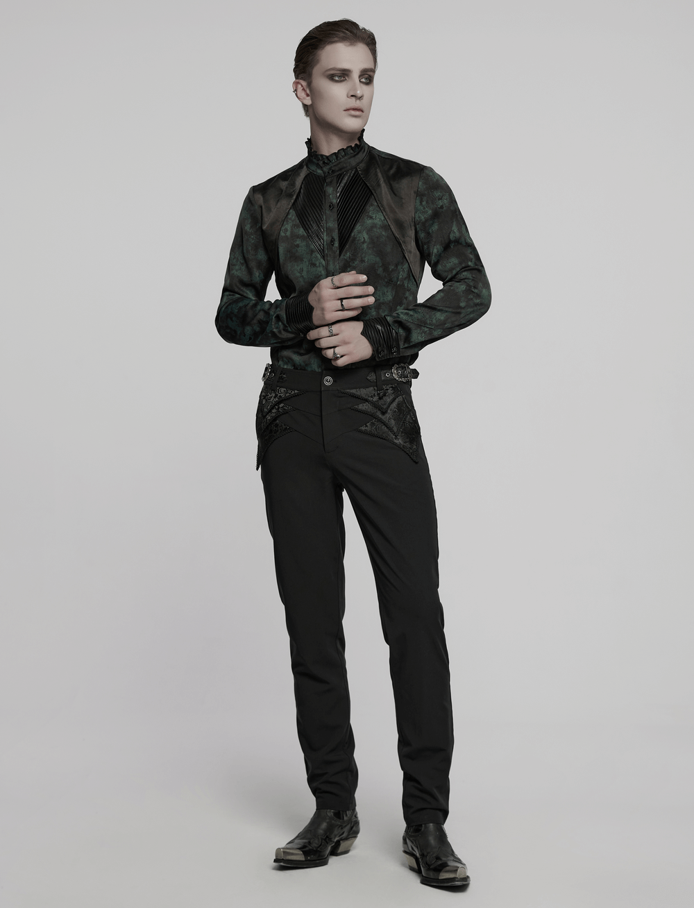 Elegant goth model wearing black lace detail trousers and a dark jacket, showcasing a stylish gothic look.