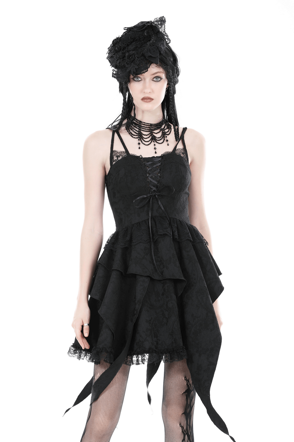 Gothic black lace dress with straps and layered skirt for evening elegance, styled with unique accessories.