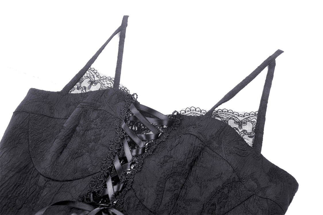Close-up of gothic black lace dress showing laced-up bodice and delicate straps for evening elegance.