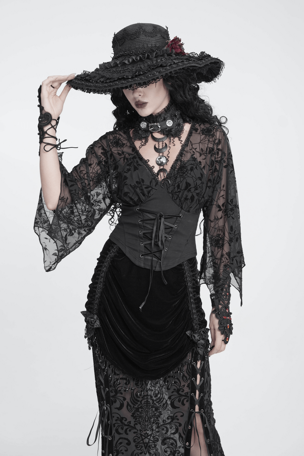 Gothic Black Lace Floral Choker with Silver Clasps worn with a dramatic black ensemble and wide-brimmed hat.
