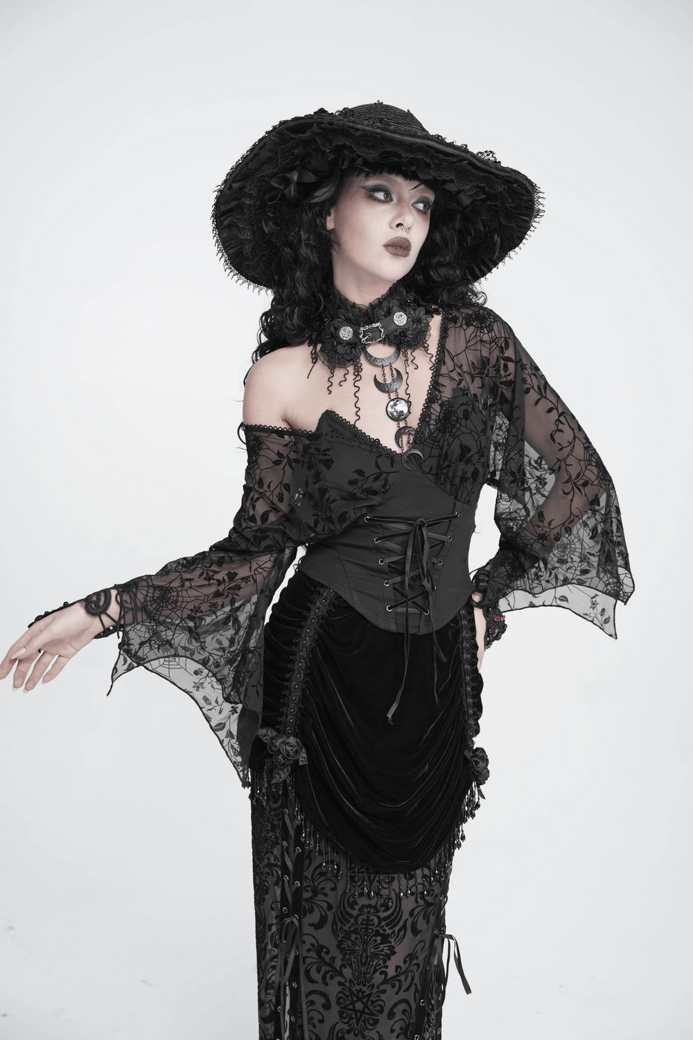 Gothic Black Lace Floral Choker with Silver Clasps worn with an elegant black dress and hat, exuding dark romantic charm.