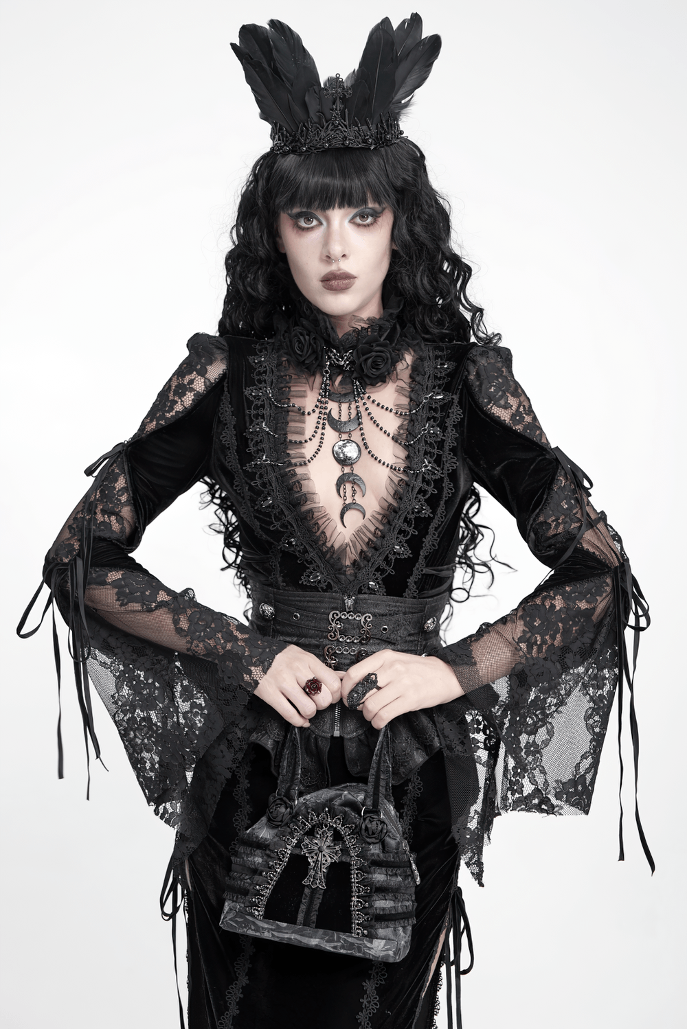 Gothic Black Lace Handbag with Cross and Rose Details held by a model in an elaborate gothic outfit.