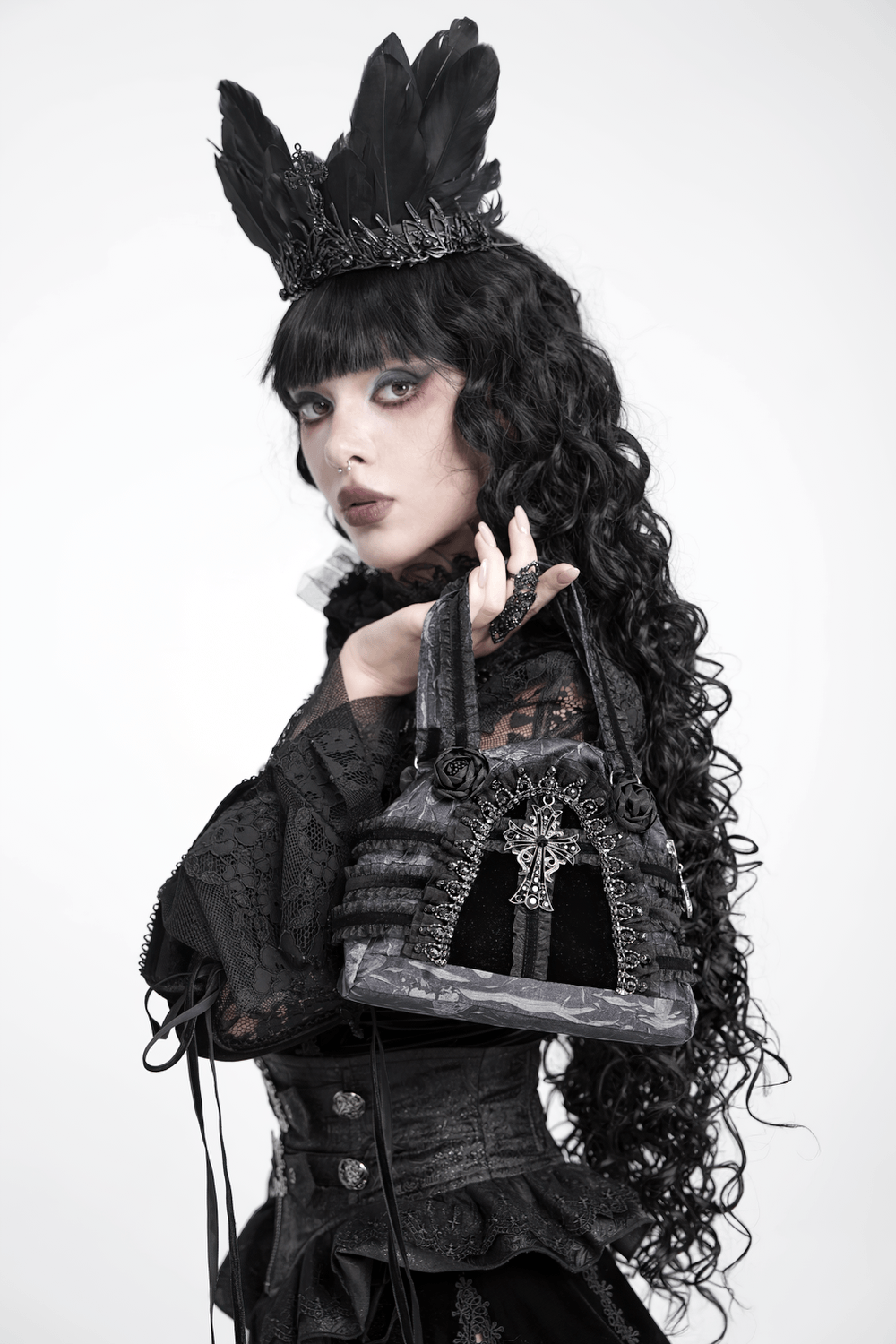 Gothic Black Lace Handbag with Cross and Rose Details displayed by model with dark attire and crown.