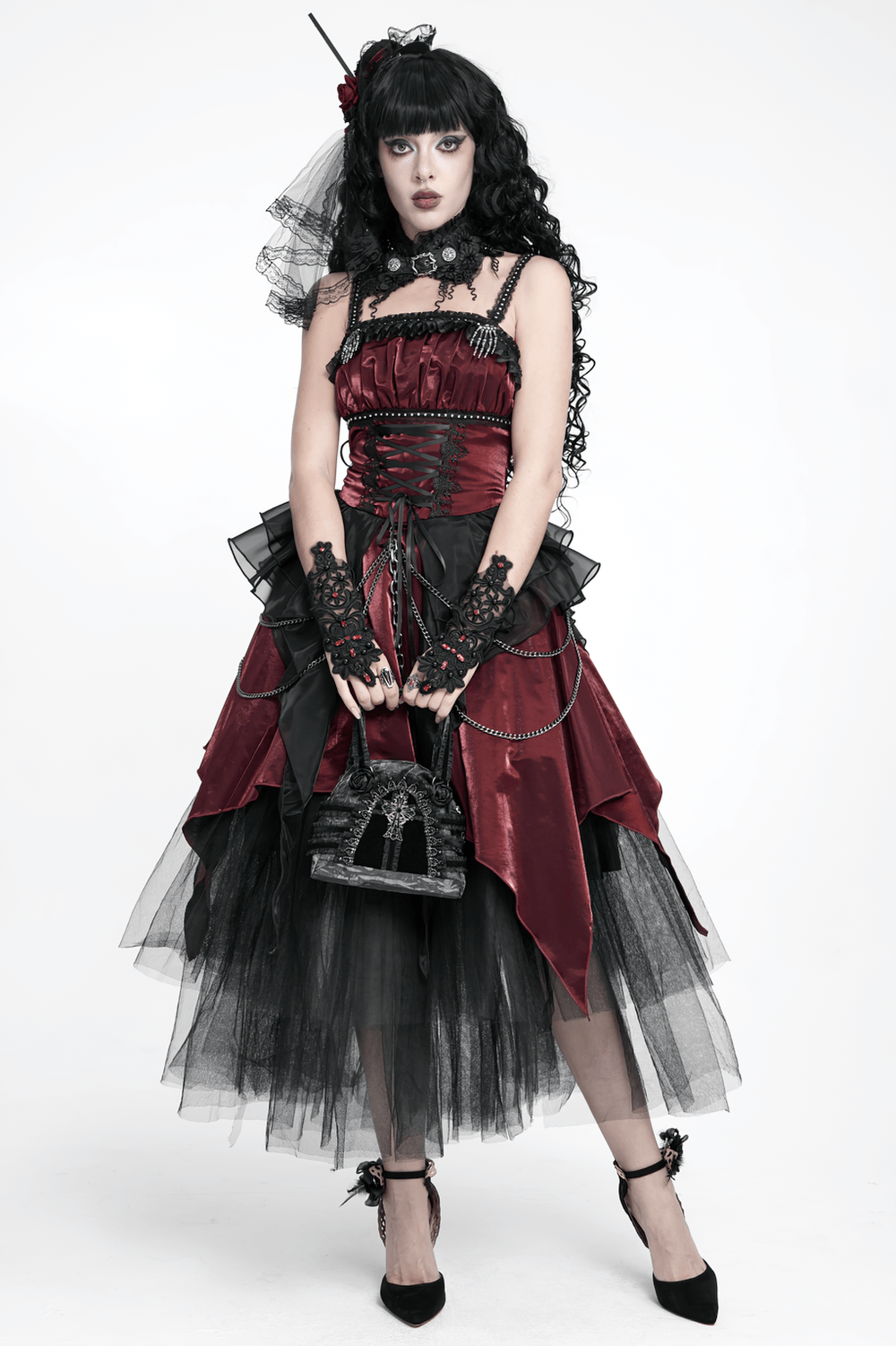 Gothic Black Lace Handbag with Cross and Rose Details held by model in dark romantic fashion attire.