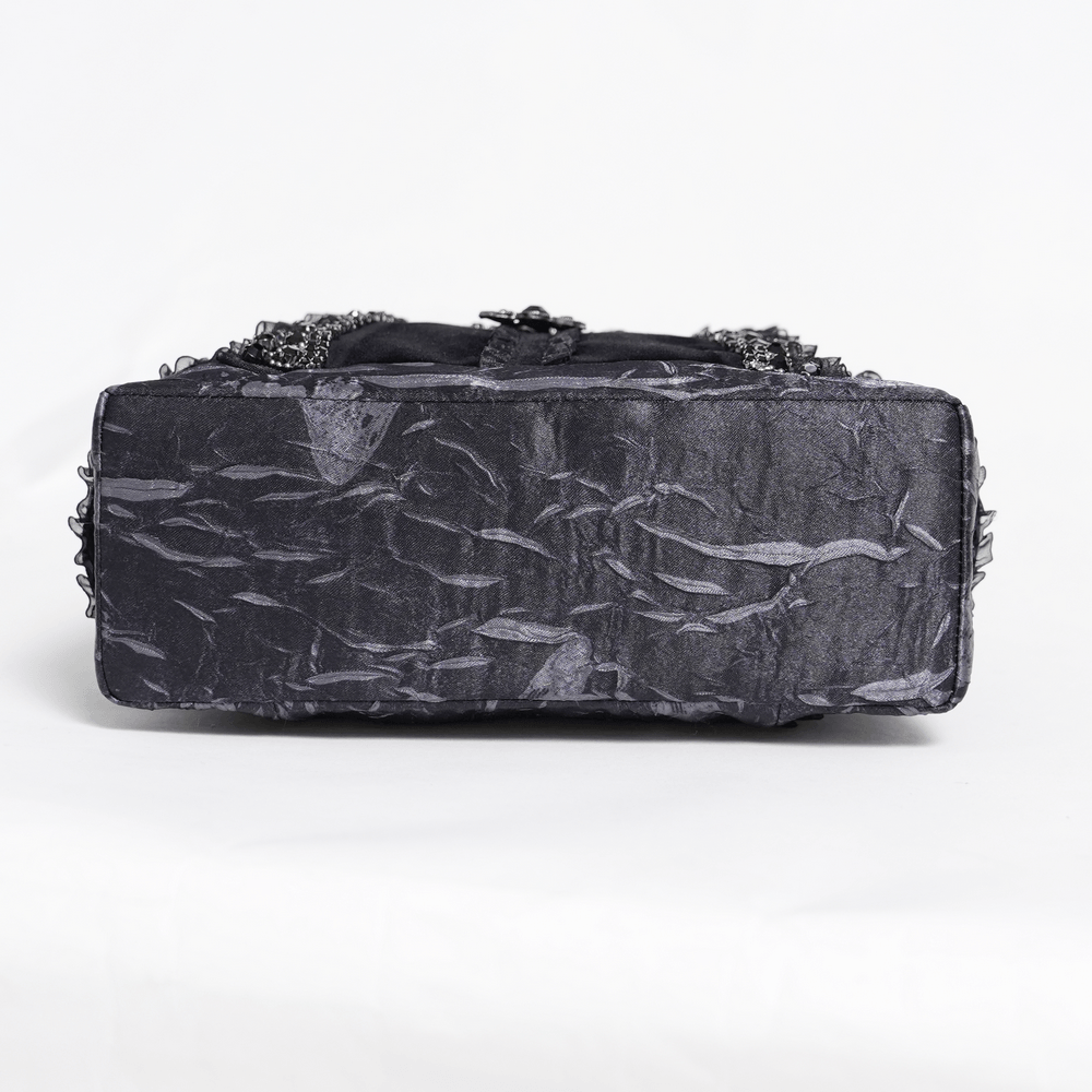 Gothic Black Lace Handbag with Cross and Rose Details showing the textured bottom view with layered lace trim.
