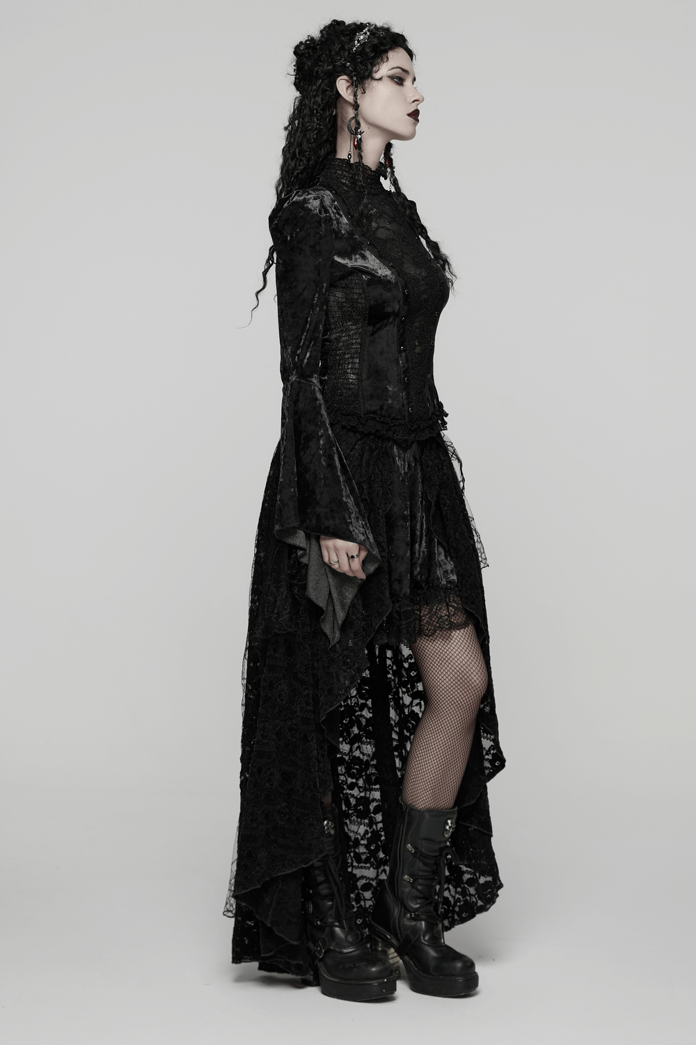 Gothic Black Lace High-Low Skirt with Velvet Detail worn by model, showcasing dramatic layers and lace texture.