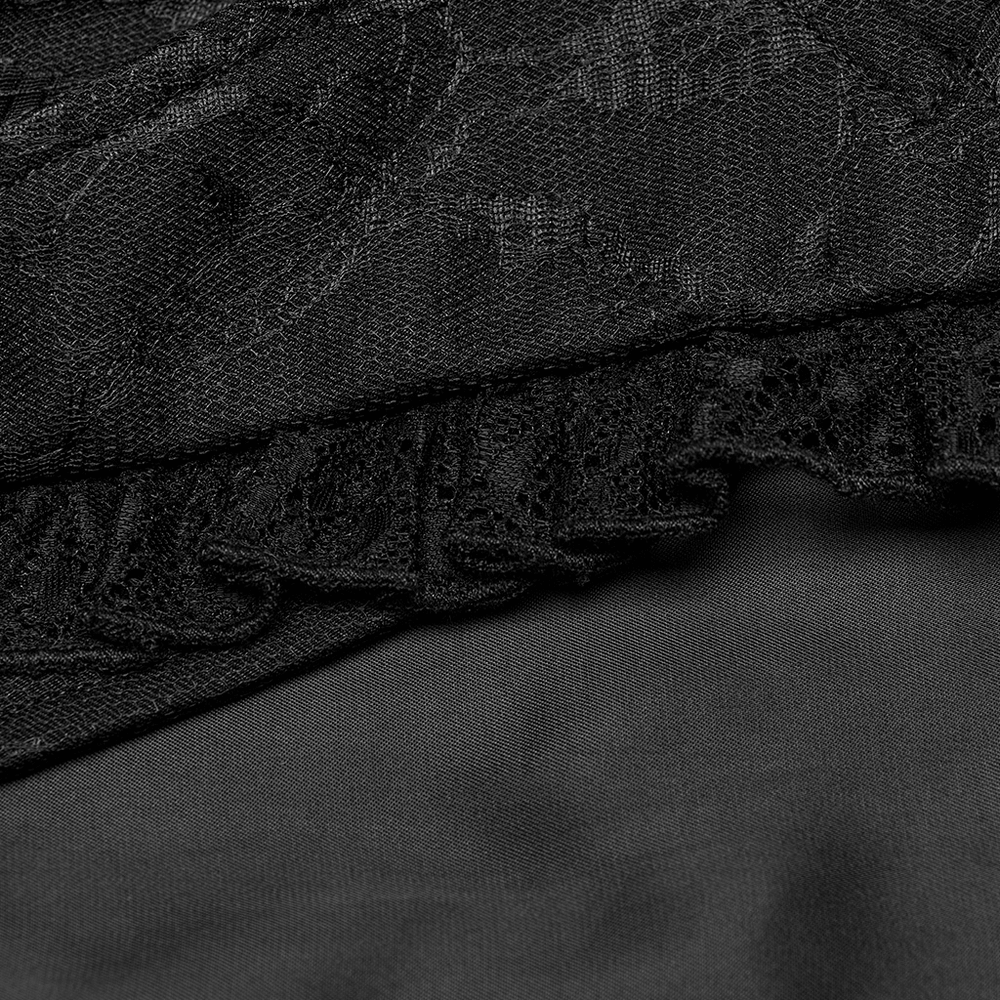 Close-up of black lace and fabric detailing of a Gothic waistcoat with ruffle accents.
