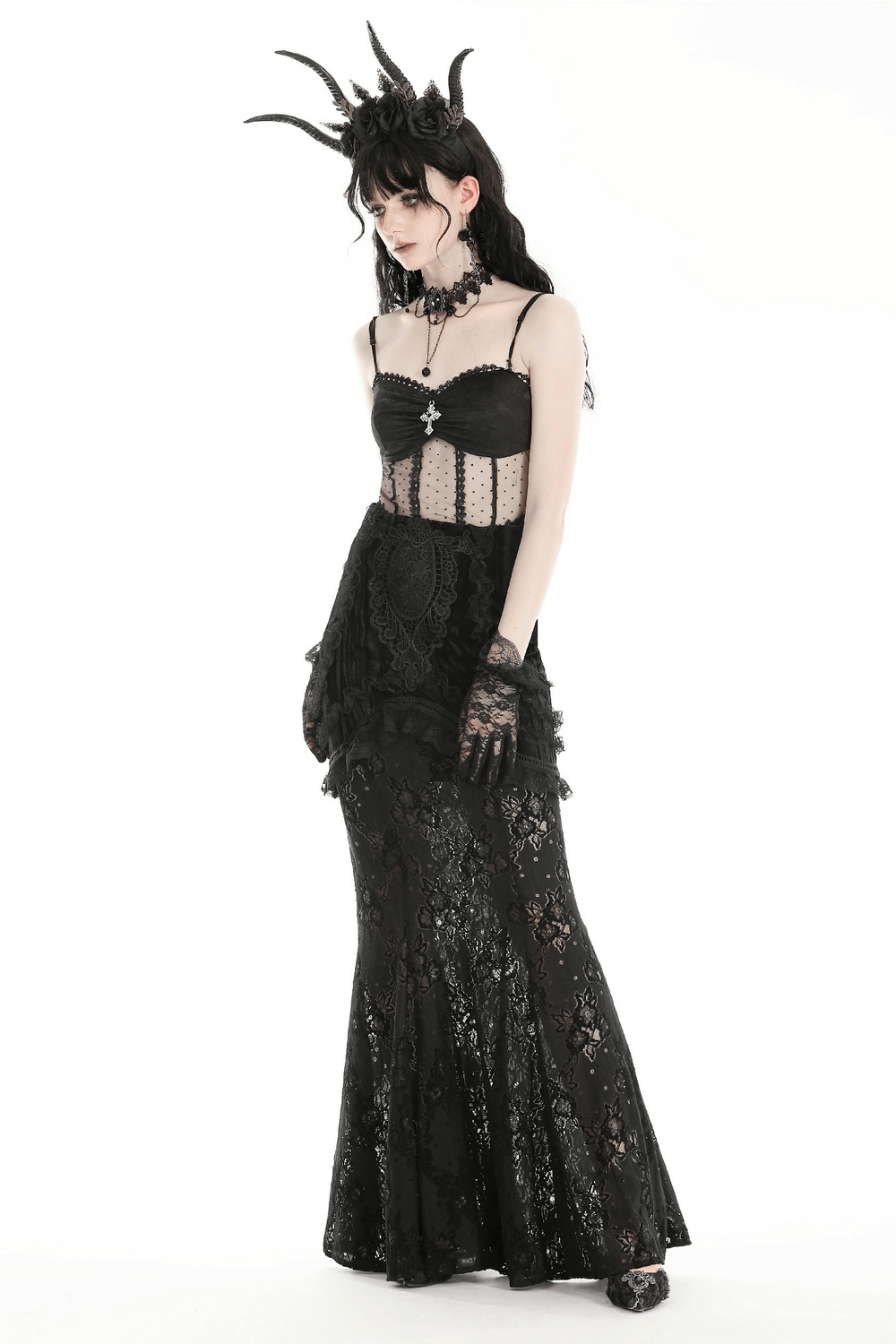 Elegant woman in gothic black lace layered long skirt with intricate detailing and accessories.