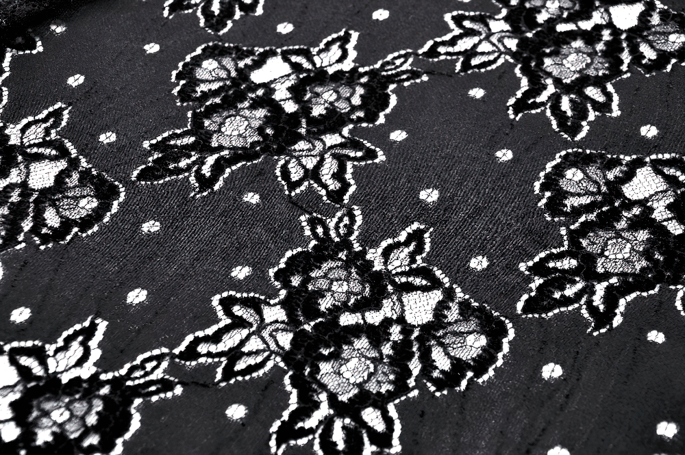Close-up of intricate black lace with floral pattern on gothic fabric, perfect for elegant women's clothing.