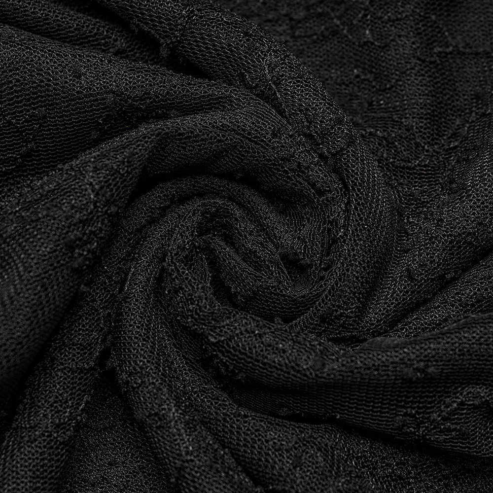 Close-up of black lace fabric showcasing intricate textures and patterns, perfect for gothic fashion.