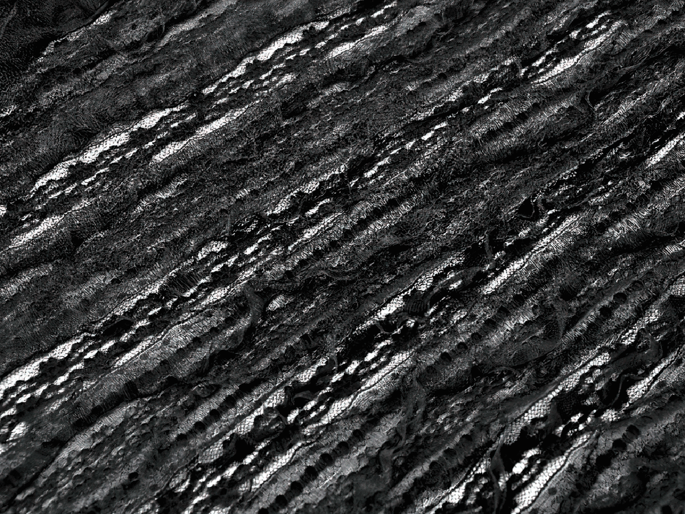 Gothic Black Lace Maxi Dress with Split Panels textured lace fabric, showcasing intricate dark patterns and flow.