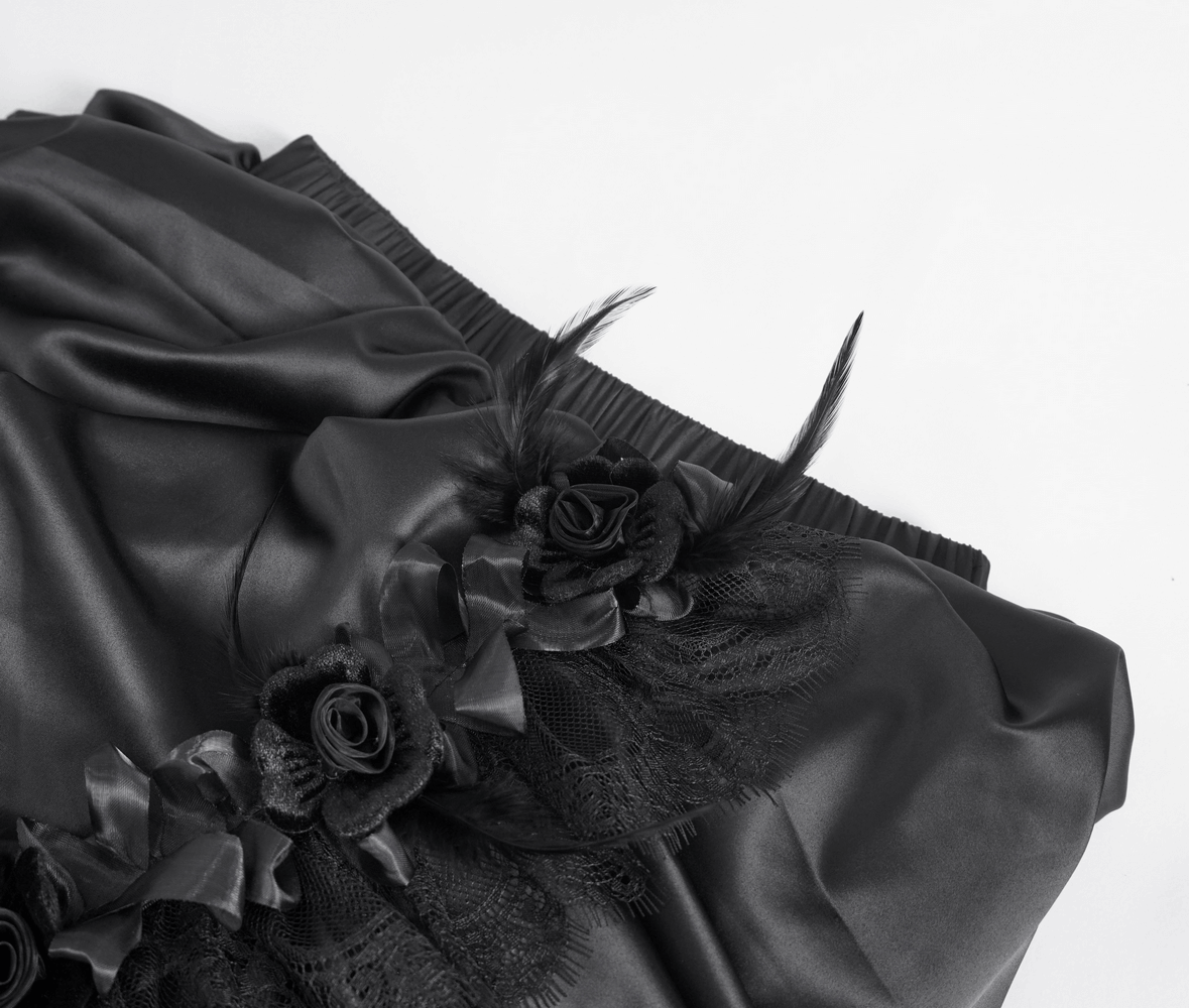 Elegant black satin skirt with lace and floral detailing, perfect for a gothic chic look.